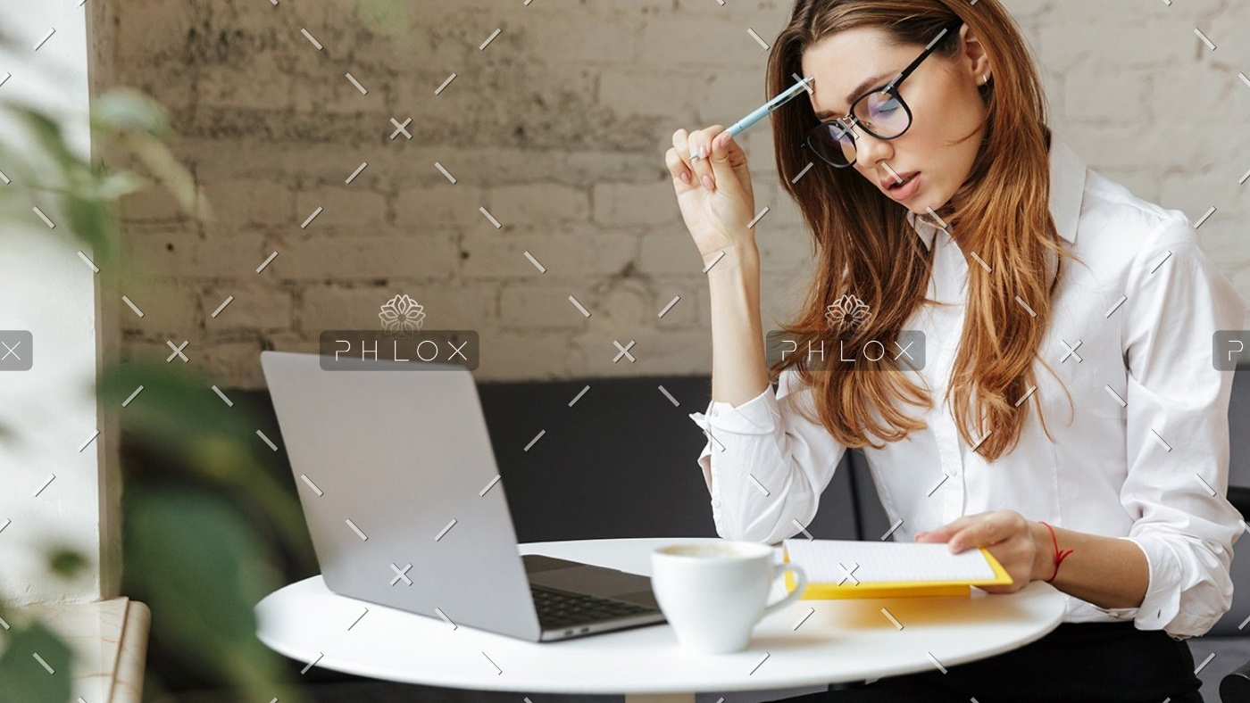 thoughtful-business-woman-indoors-using-laptop-P5HYUQX-1